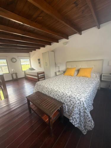 a bedroom with a bed and a wooden floor at Entre Montañas in Tafí del Valle