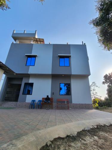 a house with two chairs in front of it at Sky n Valley in Bāndarban