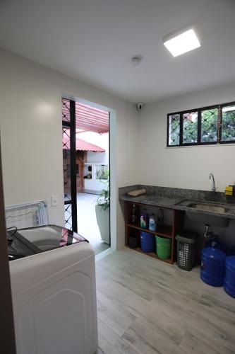 a kitchen with a sink and a counter top at Na Casa Hostel in Manaus