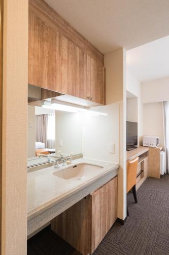 a kitchen with a sink and a counter top at Flexstay Inn Sakuragicho in Yokohama