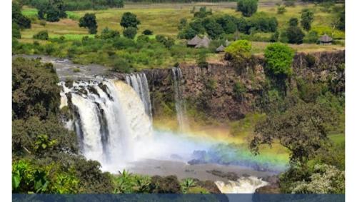 ein Regenbogen am Fuße eines Wasserfalls in der Unterkunft Explore Bahirdar Hotel in Bahir Dar