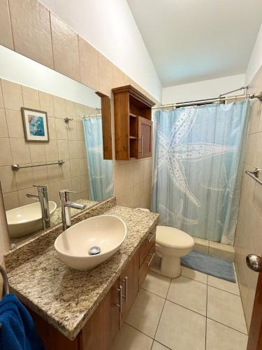 a bathroom with a sink and a toilet and a shower at Coco Maya 2b2b Villa in Coco