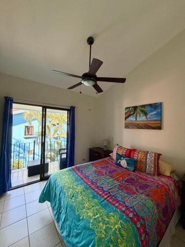 a bedroom with a bed and a ceiling fan at Coco Maya 2b2b Villa in Coco