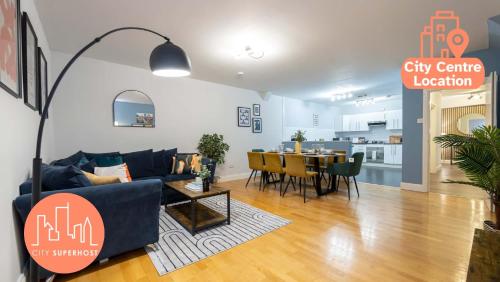 a living room with a couch and a dining room at Canal Street Apartment in Manchester