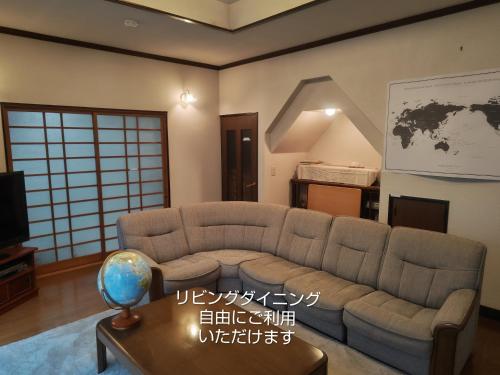 a living room with a couch and a table at 民泊よこてこよ in Yokote