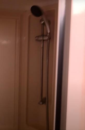 a shower with a shower head in a bathroom at Beachside Ingoldmells, 2 bedroom, Wifi in Ingoldmells
