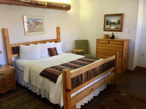 a bedroom with a large bed and a dresser at Guadalupe Inn in Santa Fe