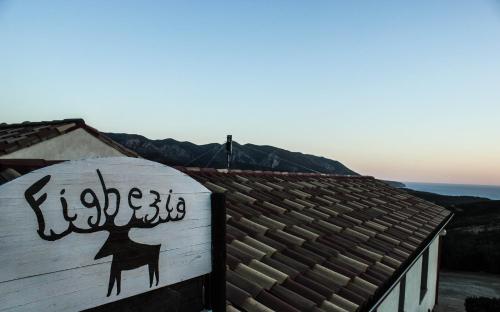 a sign on the side of a building with writing on it at Fighezia in Fluminimaggiore