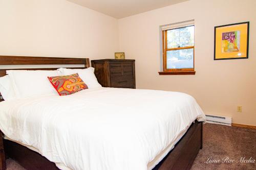 a bedroom with a large white bed and a window at Durango Colorado Four Bedroom Two Bathroom Home in Durango