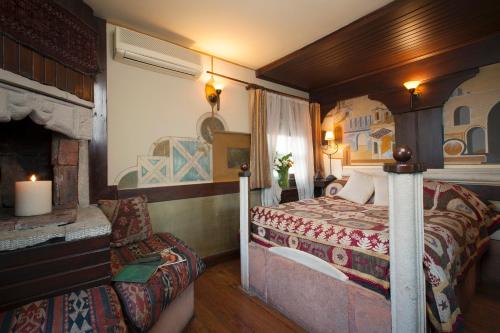 a bedroom with a bed and a fireplace at Hotel Empress Zoe in Istanbul