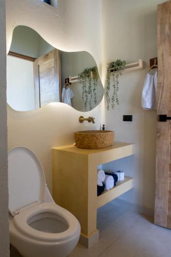 a bathroom with a sink and a toilet at Corales de Isla Fuerte in Puerto Limón
