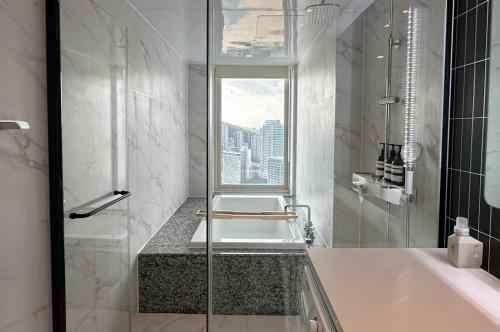 a bathroom with a sink and a window at Hyoi Stay Busan Songdo in Damyang