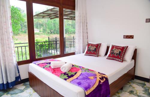 two beds in a room with a window at Ella River Breeze Homestay in Ella