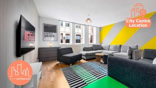a living room with a couch and a tv at Iconic Canal Street Apt by City SuperHost in Manchester