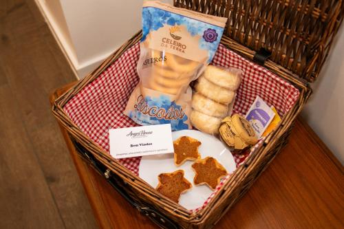 a basket with snacks and crackers and bread at AngraHouse in Angra do Heroísmo