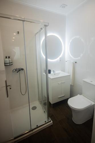 a bathroom with a shower and a toilet and a sink at AngraHouse in Angra do Heroísmo