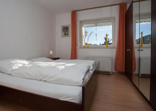 a bedroom with a large bed and a window at Apartment Am Kleehagen 26, Winterberg-Niedersfeld in Winterberg