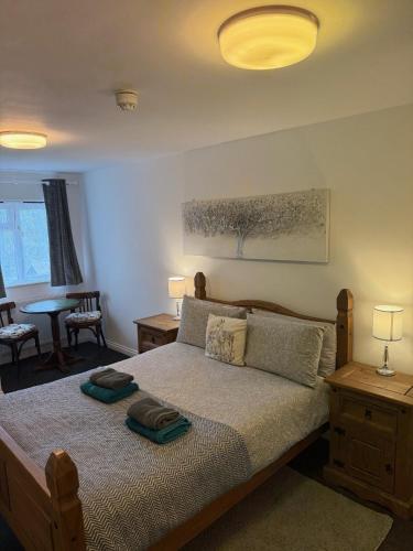 a bedroom with a large bed with two lamps on it at The BILLINGFORD HORSESHOES in Scole