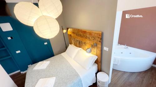a bedroom with a bed and a bath tub at Hotel Nizza Creative Hotel in Rimini
