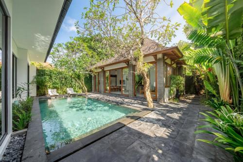 an exterior view of a villa with a swimming pool at Mimosa - Private Pool Escape with Panoramic Views in Kerobokan