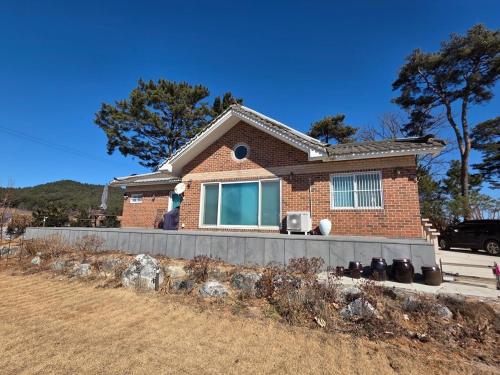 a brick house with a fence in front of it at Mooldan Dongsan Taean in Taean