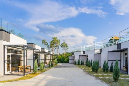 an exterior view of a house with a pathway at Pool Lounge Pension & Glamping in Yangyang