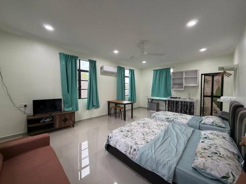 a bedroom with a bed and a television and a table at Dikmad Studio Room Bukit Mentok, Kemaman in Cukai