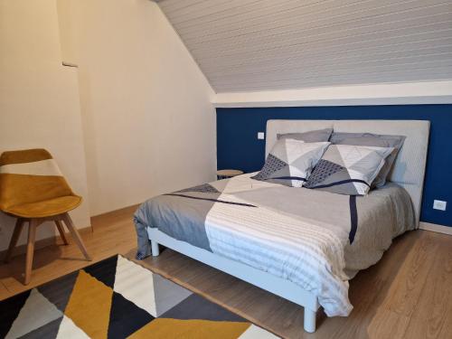 a bedroom with a bed with a blue wall at Les Terrasses de Laguiole in Laguiole