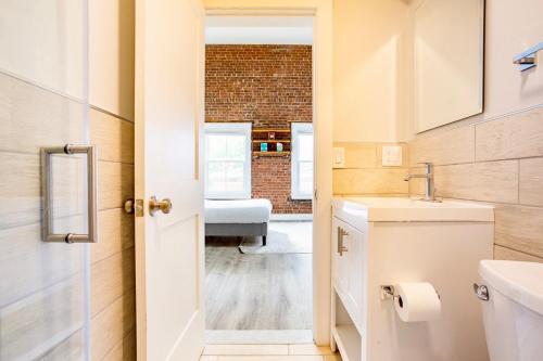a bathroom with a sink and a toilet and a sink at Bright Downtown Studio near Yale & East Rock! in New Haven