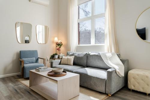 a living room with a couch and a table at Central 2BR Near Yale WiFi with Washer and Dryer in New Haven