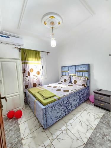 a bedroom with a large bed in a room at FOKOU House in Yaoundé