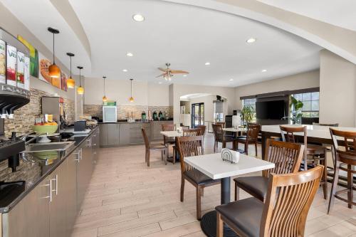 a dining room and kitchen with tables and chairs at Quality Inn & Suites Lexington in Lexington