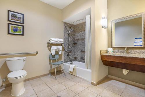 a bathroom with a toilet and a shower and a sink at Comfort Suites Old Town Spring in Spring