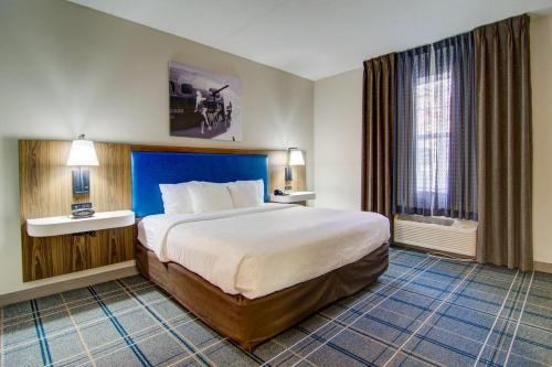 a hotel room with a large bed and a window at Comfort Suites Newport News Airport in Newport News