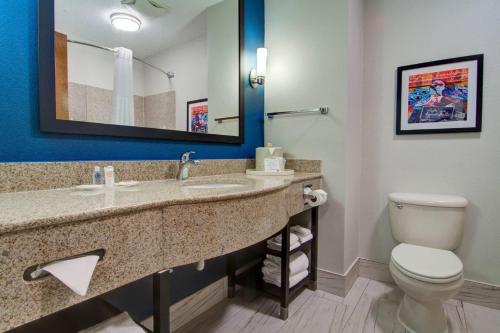 a bathroom with a toilet and a sink at Comfort Suites Newport News Airport in Newport News