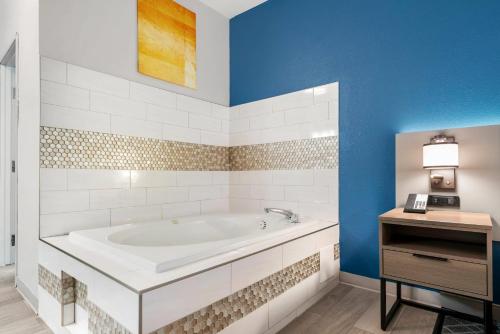 a bathroom with a white tub and blue walls at Comfort Inn & Suites in Wisconsin Dells