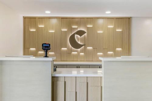 a reception area with a logo on a wall at Comfort Inn Sea World Area in San Diego