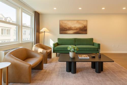 a living room with a green couch and chairs at Westville Haven Modern 2BR Near Yale in New Haven