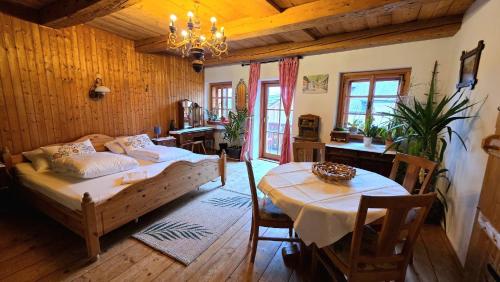 a bedroom with a bed and a table in it at Café Pension Leopoldine in Hallstatt