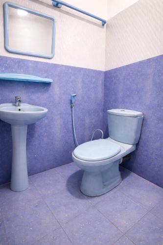 a bathroom with a toilet and a sink at Pearl Rest in Mannar