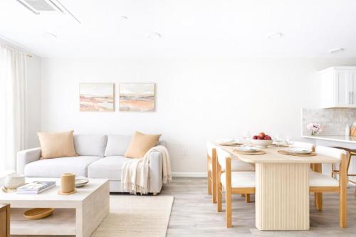 a living room with a white couch and a table at DTWN Yale Wooster Square Laundry in New Haven