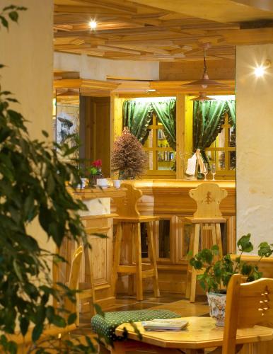 a kitchen with a counter and a table and chairs at Hotel le Petit Dru in Morzine