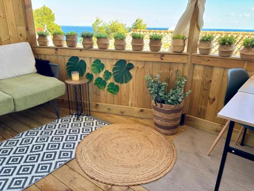 a room with a table and chairs and potted plants at Casa Halcón in Jávea