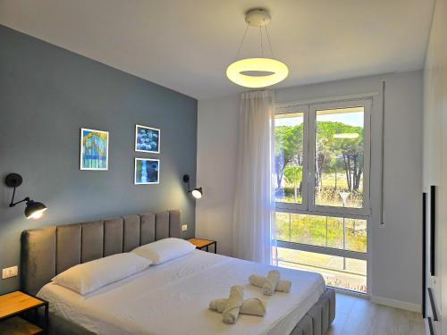 a bedroom with a large bed with two towels on it at White Moon Apartment 301 in Lalzit Bay