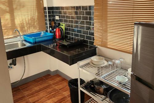 a kitchen with a sink and a counter top at Mangrove Beach Houses in Srithanu