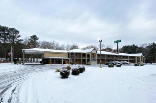 a building covered in snow in a parking lot at Quality Inn Kenly I-95 in Kenly