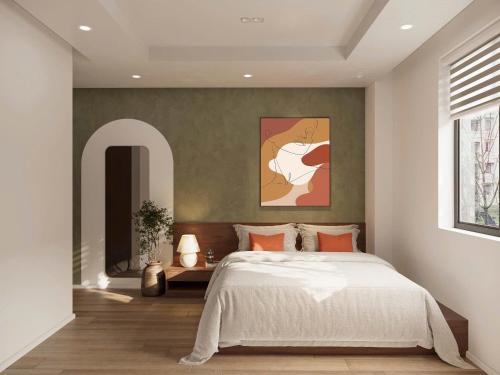 a bedroom with a bed and a painting on the wall at V Living - Downtown Saigon Stay with Free Laundry in Ho Chi Minh City