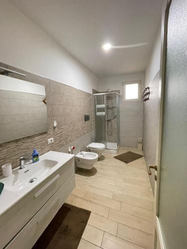 a bathroom with a sink and a toilet and a shower at Villa Coco Monopoli in Monopoli