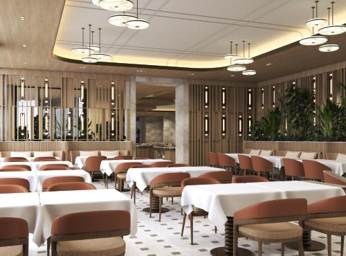 a dining room with white tables and chairs at Merit Crystal Cove Hotel Casino & SPA in Kyrenia