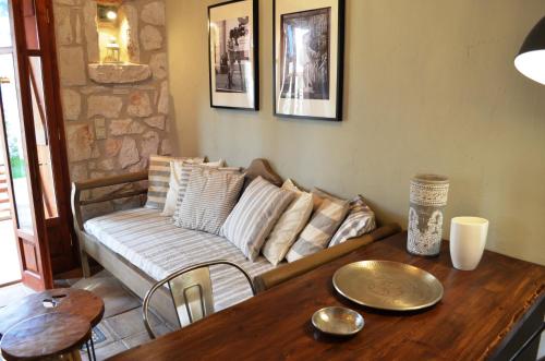 a living room with a couch and a wooden table at Alegria Villas Complex in Vasilikos